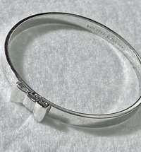 Silver tone Kate Spade “Take a Bow” bangle bracelet